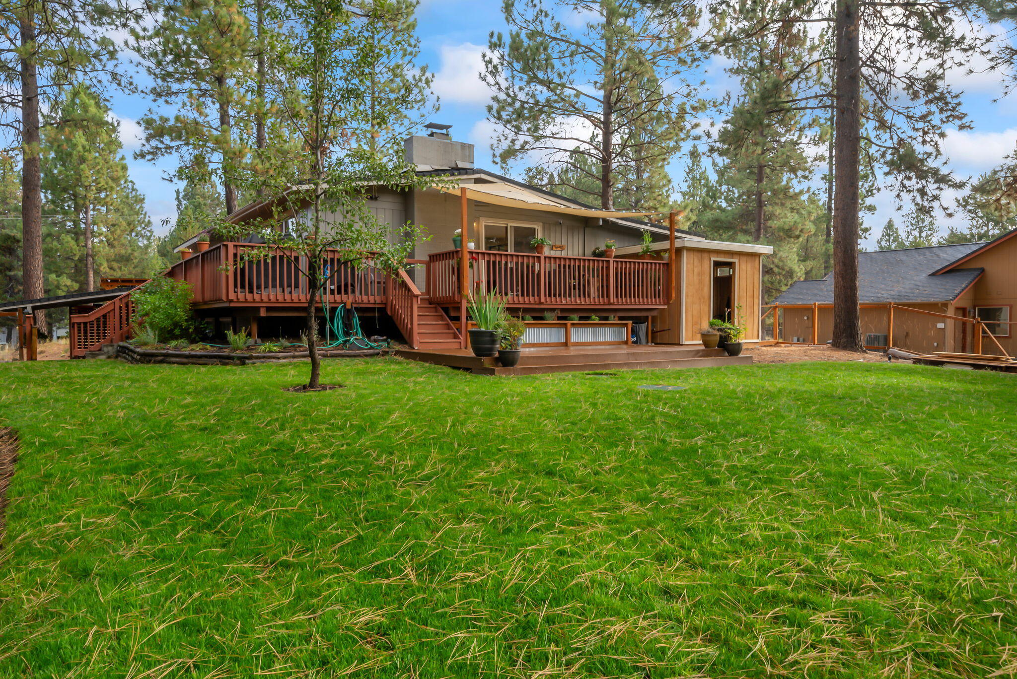 16879 Elsinore Road Bend, OR 97707 - Photo 39 of 48 a view of a house with a yard porch and sitting area