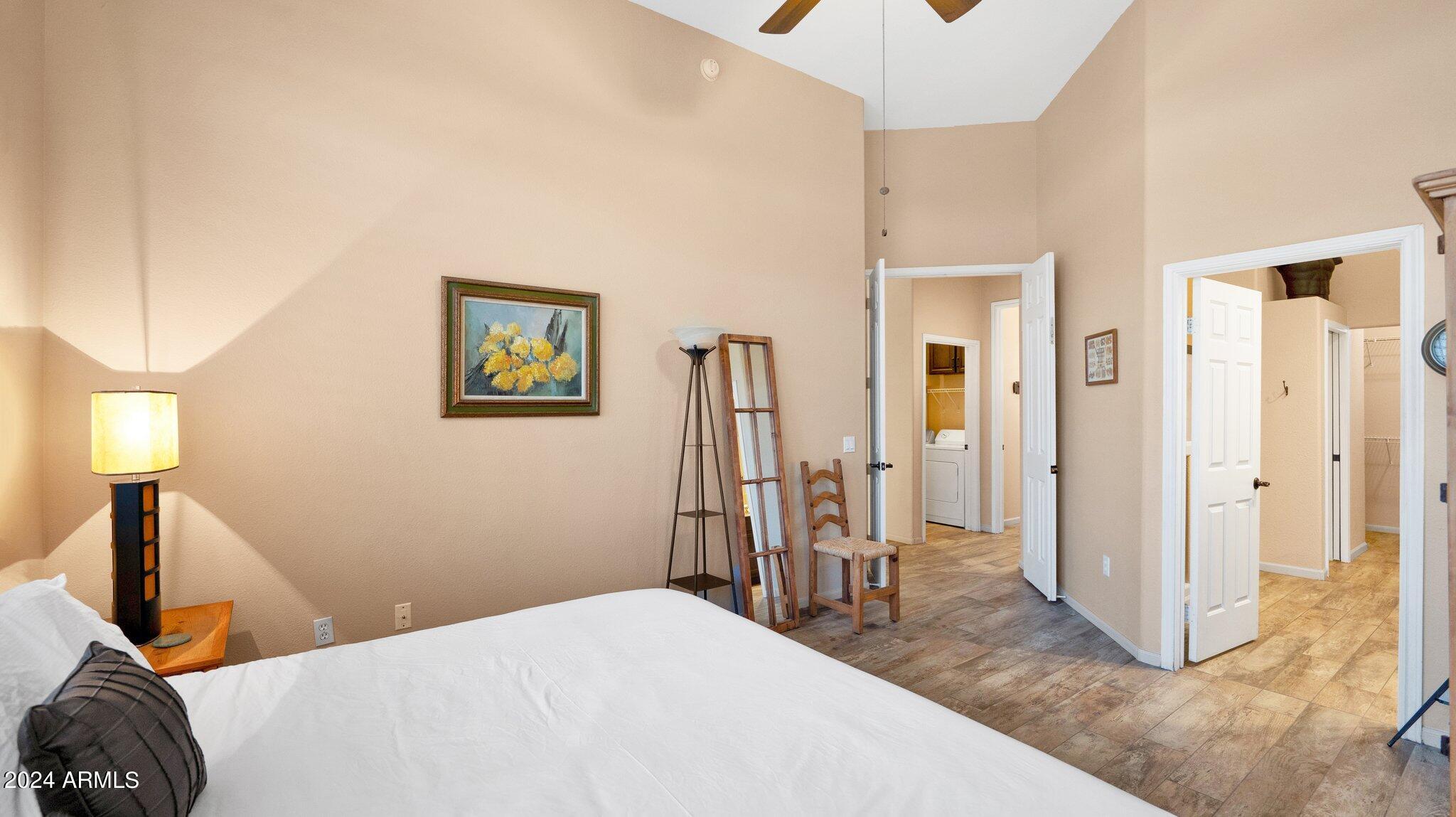 8245 East Bell Road, Unit 207 Scottsdale, AZ 85260 - Photo 13 of 33 a bedroom with a bed and a mirror