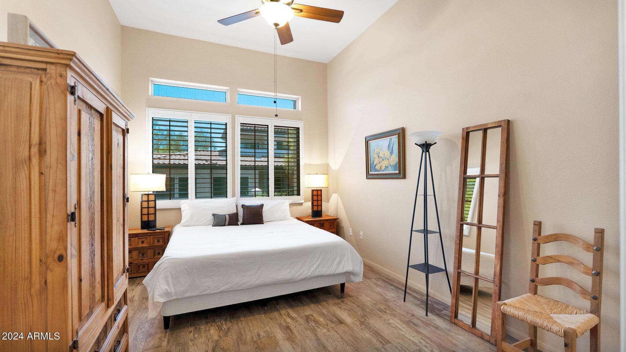 8245 East Bell Road, Unit 207 Scottsdale, AZ 85260 - Photo 14 of 33 a bedroom with a large bed and a window