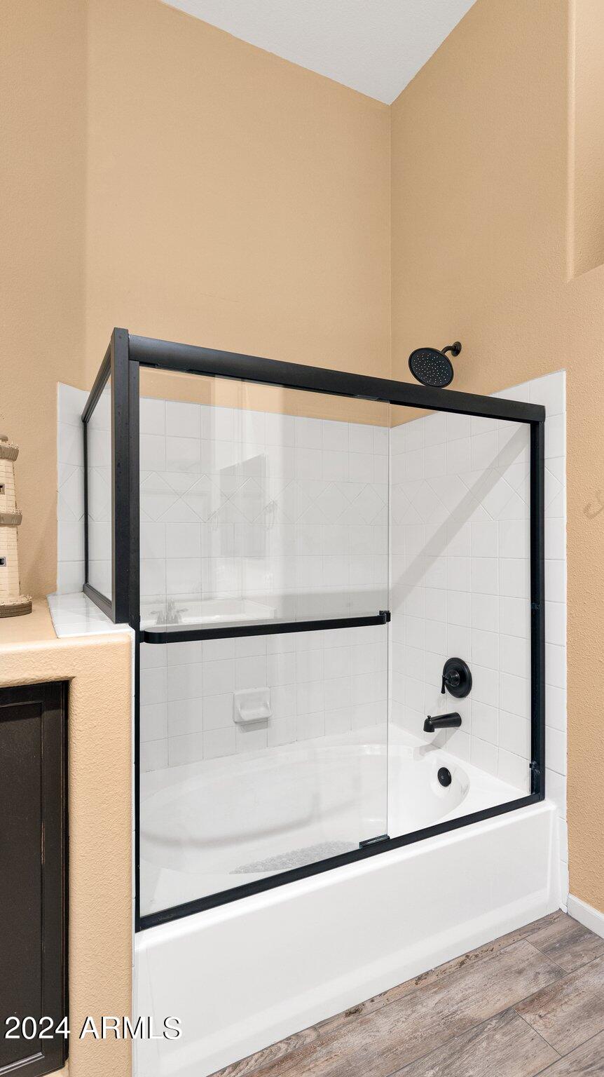 8245 East Bell Road, Unit 207 Scottsdale, AZ 85260 - Photo 16 of 33 a bathroom with a shower and mirror