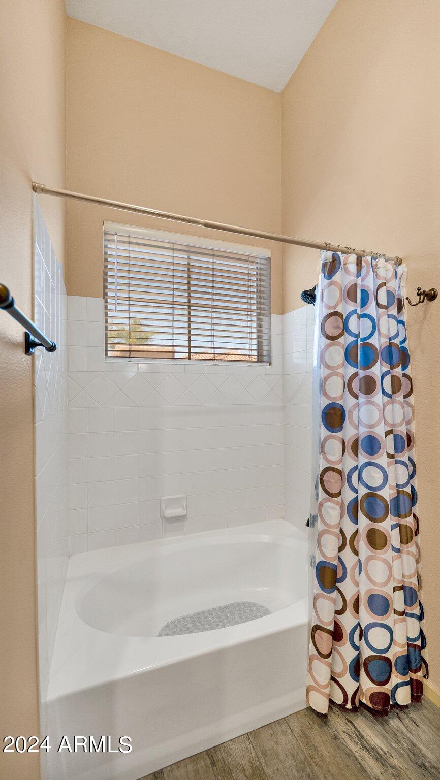 8245 East Bell Road, Unit 207 Scottsdale, AZ 85260 - Photo 21 of 33 a bathroom with a bathtub and a shower