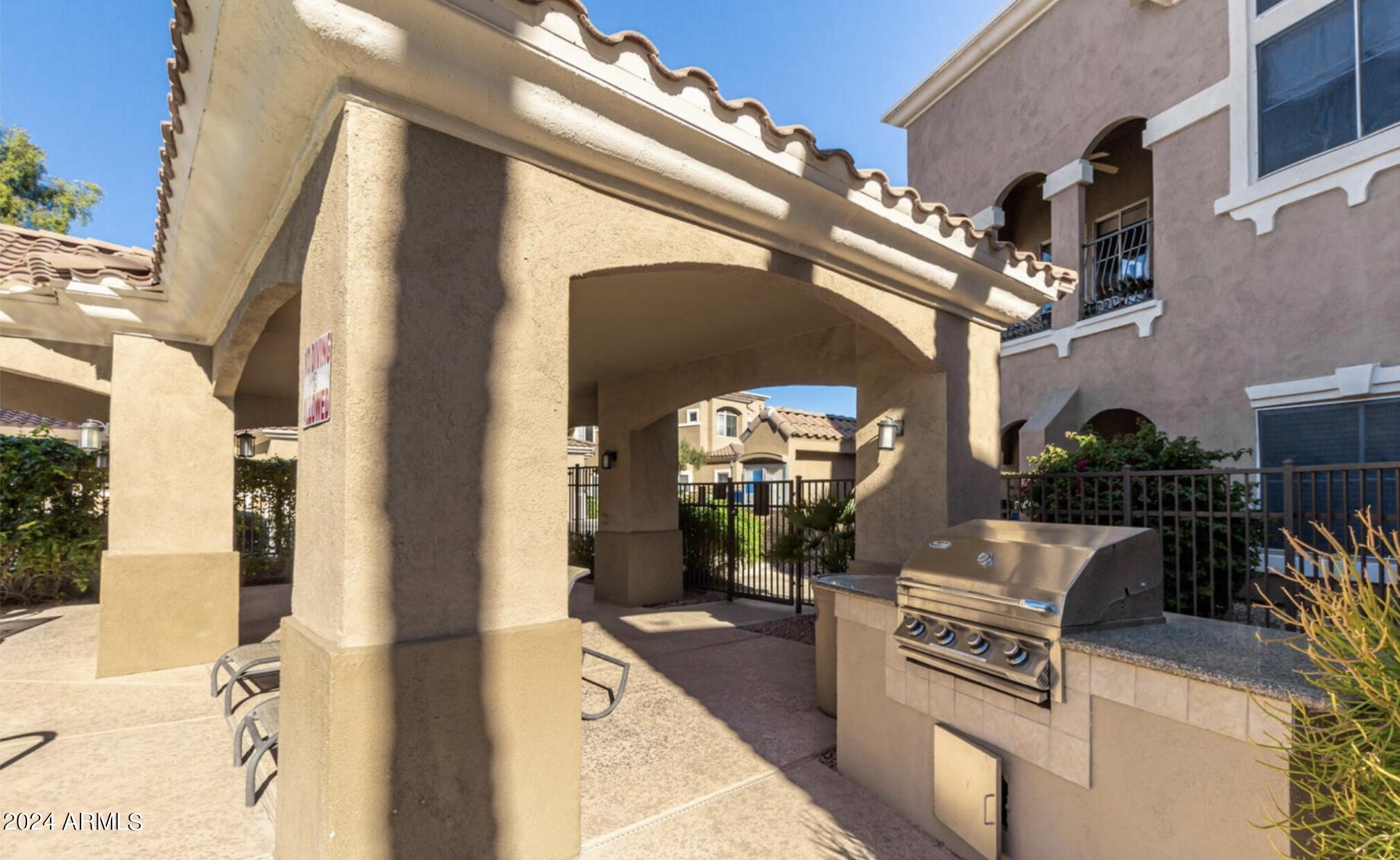 8245 East Bell Road, Unit 207 Scottsdale, AZ 85260 - Photo 28 of 33 a view of a entryway with furniture and floor to ceiling window