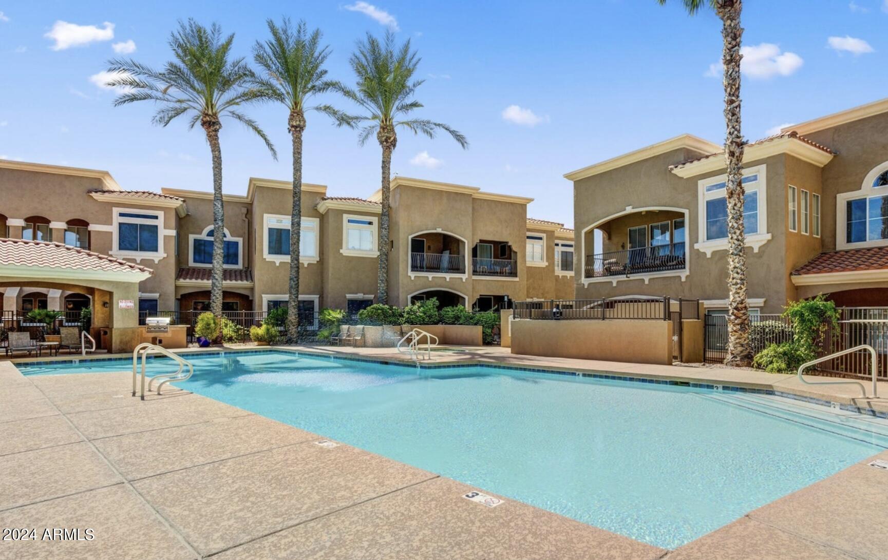 8245 East Bell Road, Unit 207 Scottsdale, AZ 85260 - Photo 32 of 33 a front view of multiple houses with yard