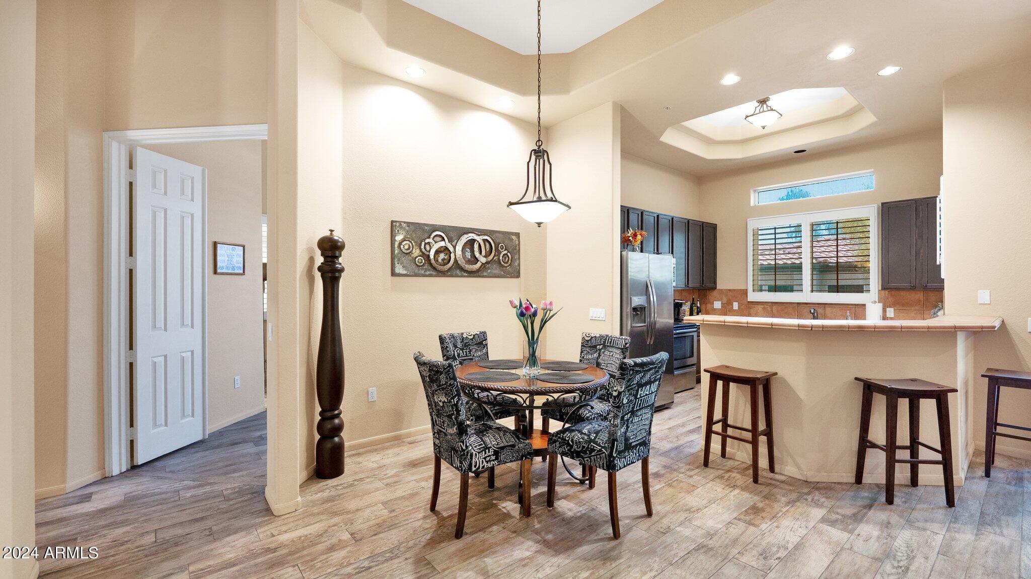 8245 East Bell Road, Unit 207 Scottsdale, AZ 85260 - Photo 6 of 33 a view of a dining room with furniture