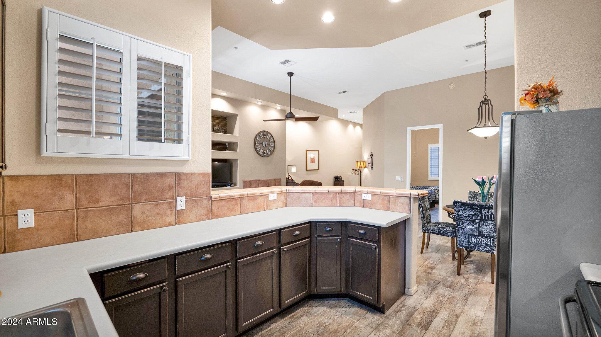 8245 East Bell Road, Unit 207 Scottsdale, AZ 85260 - Photo 10 of 33 a kitchen with a sink cabinets and window