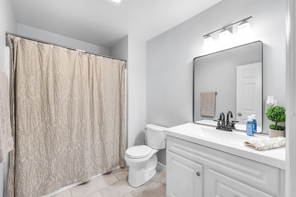 114 Riverton Road Springfield, MA 01109 - Photo 15 of 33 a bathroom with a toilet a sink and a mirror