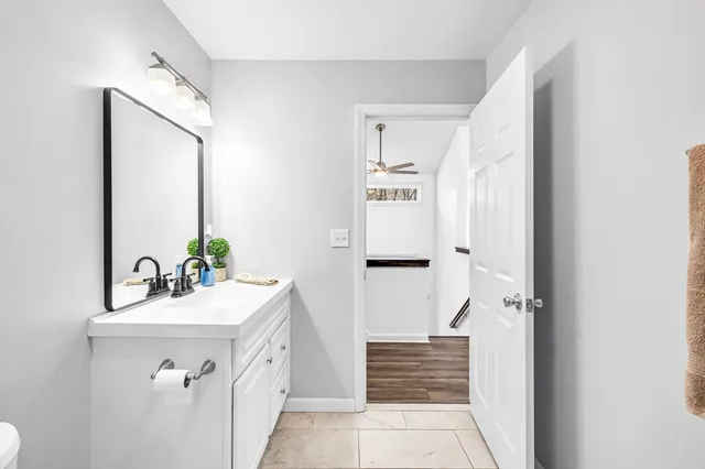 a bathroom with a sink a toilet and shower curtain