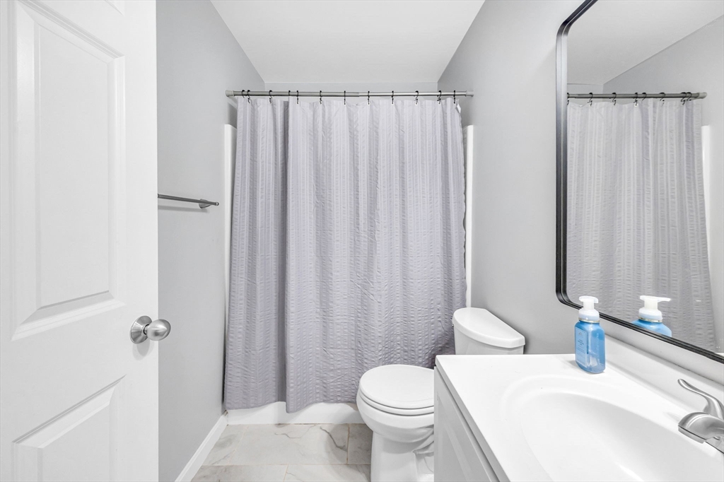 114 Riverton Road Springfield, MA 01109 - Photo 19 of 33 a bathroom with a sink a toilet and shower curtain