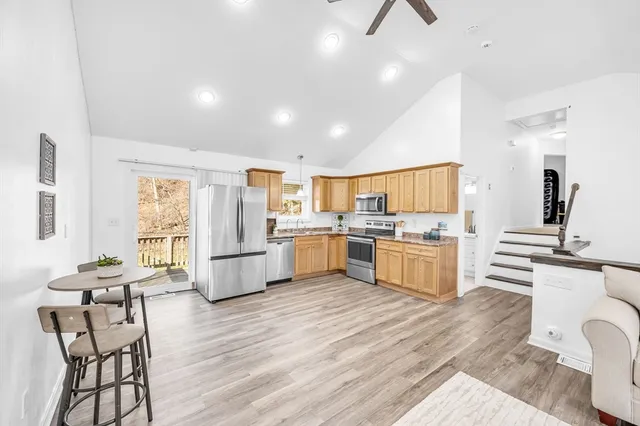 a kitchen with a sink cabinets and wooden floor