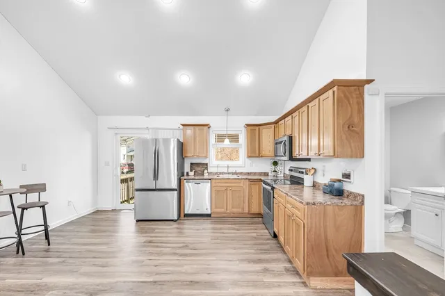 a kitchen with stainless steel appliances granite countertop a stove and a refrigerator