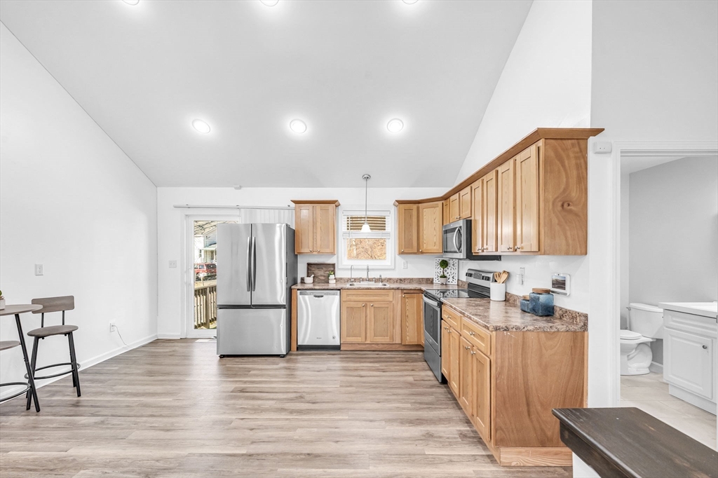 114 Riverton Road Springfield, MA 01109 - Photo 9 of 33 a kitchen with stainless steel appliances granite countertop a stove and a refrigerator