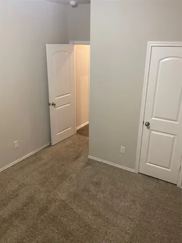 an empty room with a wooden door