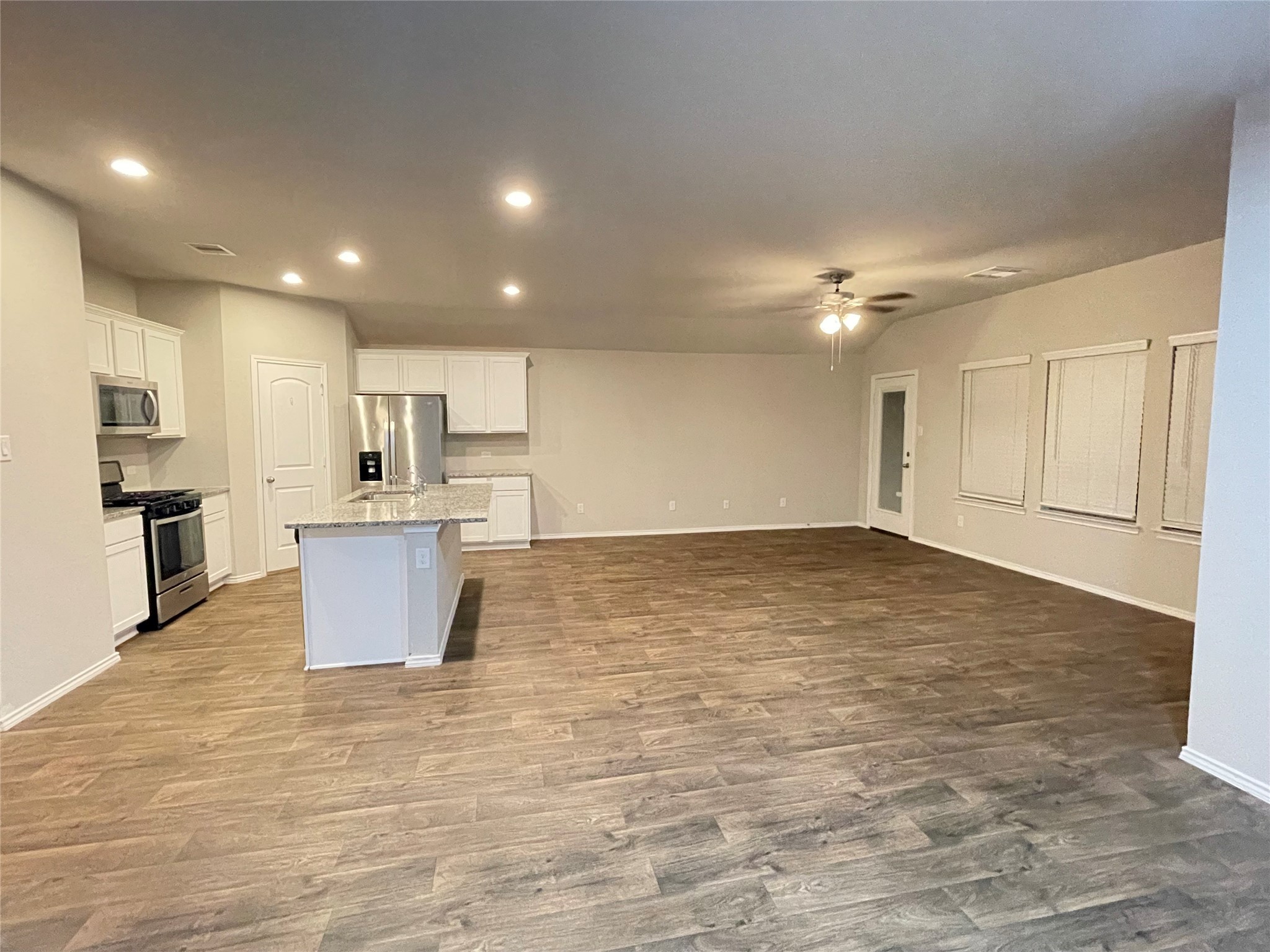 16004 Birch Bay Lane Conroe, TX 77384 - Photo 2 of 24 a view of kitchen and empty room with wooden floor