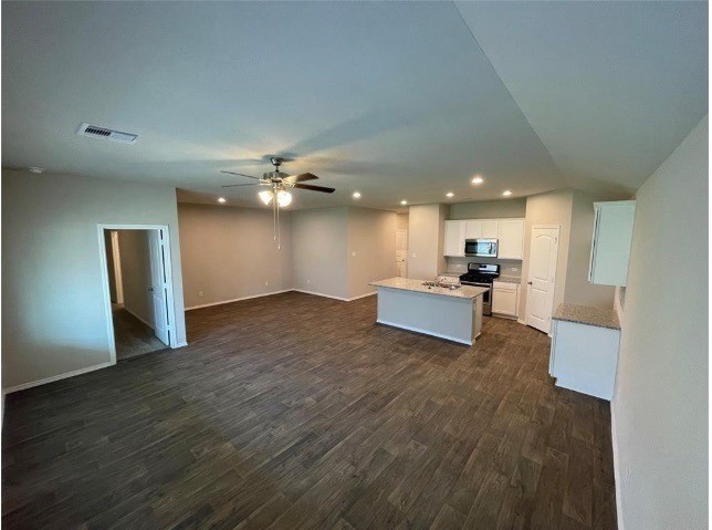 16004 Birch Bay Lane Conroe, TX 77384 - Photo 5 of 24 a view of a kitchen with a sink and a refrigerator