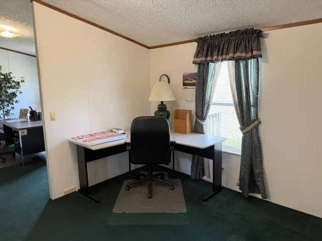 a workspace with furniture and window