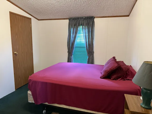 a bedroom with a bed and a closet