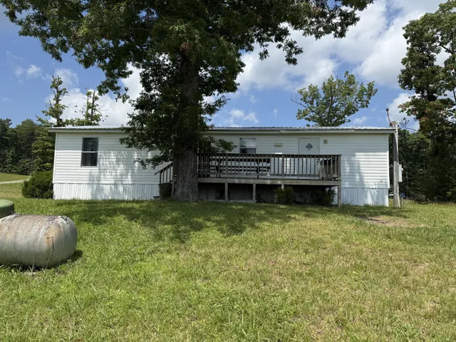 a view of a house with a backyard