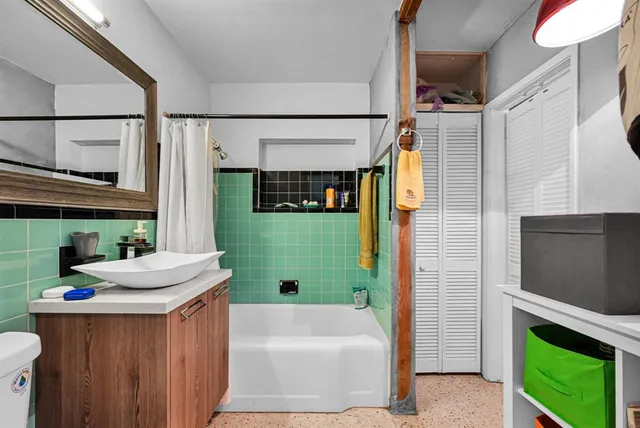 a bedroom with a bed and a painting on the wall