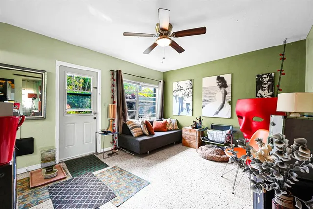 a bedroom with furniture and a ceiling fan