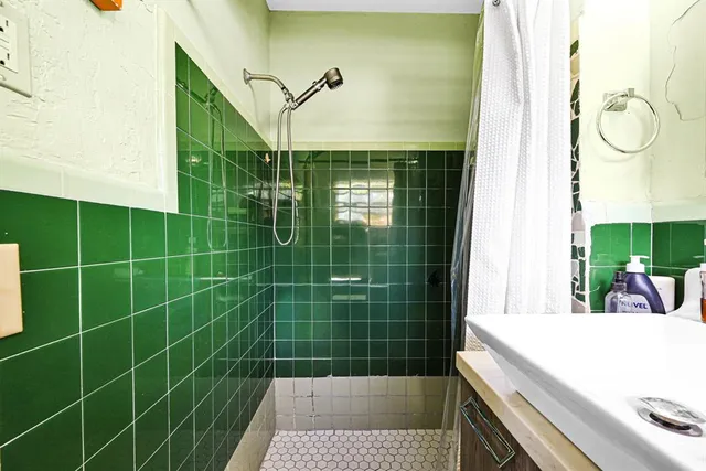 a utility room with dryer washer and a view of living room