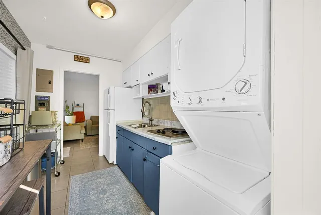 a kitchen with sink stove and cabinets