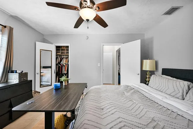 a bedroom with a bed and a chair