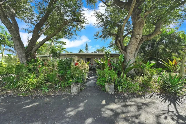 a front view of house with a garden and patio