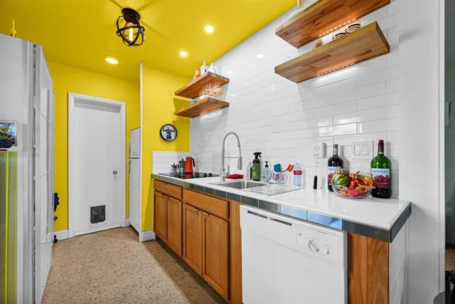 a kitchen with sink and cabinets