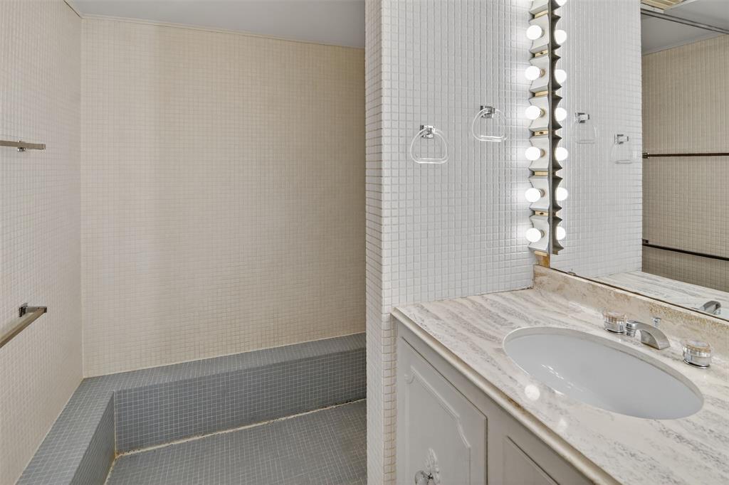 904 Northwest 7th Avenue Mineral Wells, TX 76067 - Photo 16 of 36 Bathroom featuring tile walls and vanity