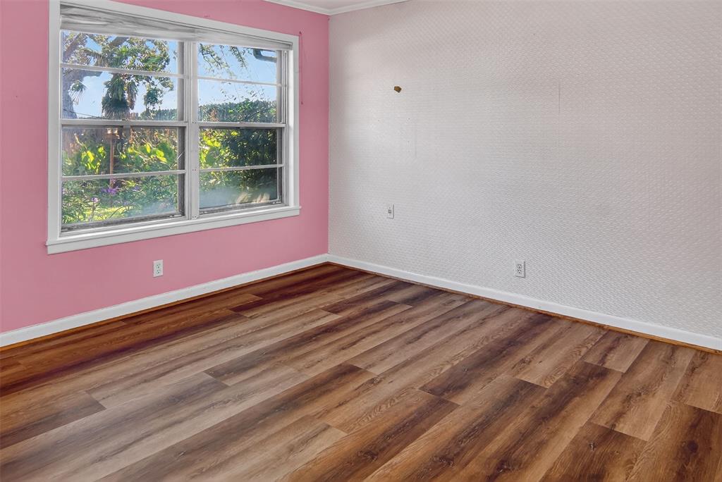 904 Northwest 7th Avenue Mineral Wells, TX 76067 - Photo 19 of 36 Spare room with wood finished floors and ornamental molding