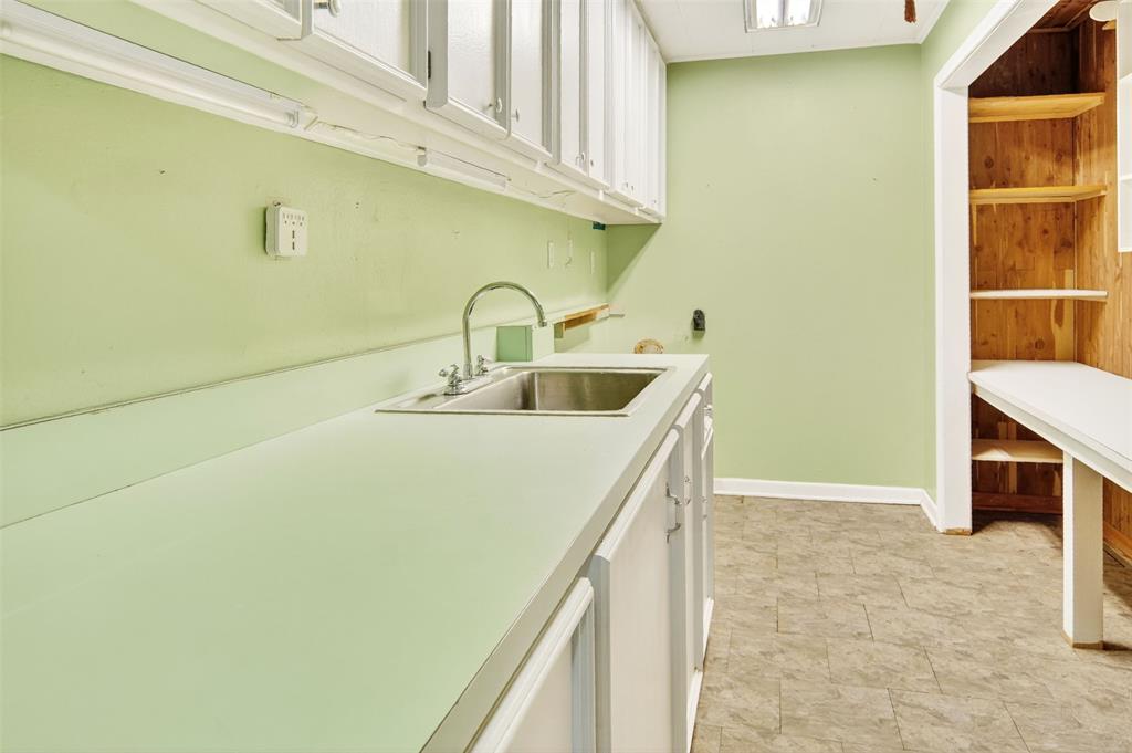 904 Northwest 7th Avenue Mineral Wells, TX 76067 - Photo 26 of 36 Laundry area featuring baseboards and cabinet space