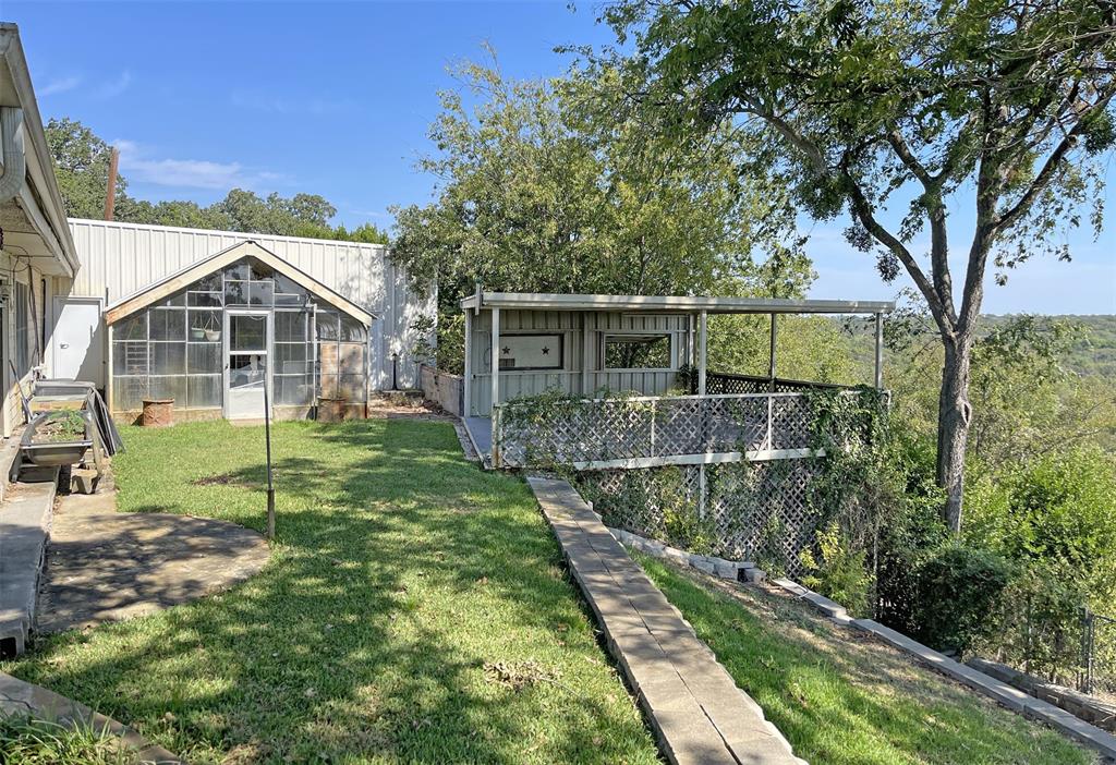 904 Northwest 7th Avenue Mineral Wells, TX 76067 - Photo 31 of 36 View of yard with an outdoor structure and an exterior structure