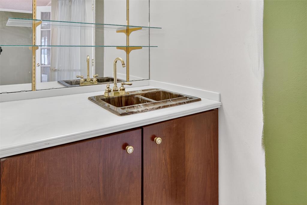 904 Northwest 7th Avenue Mineral Wells, TX 76067 - Photo 10 of 36 Indoor wet bar with light countertops and brown cabinets