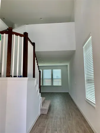 a view of a room with wooden floor and stairs