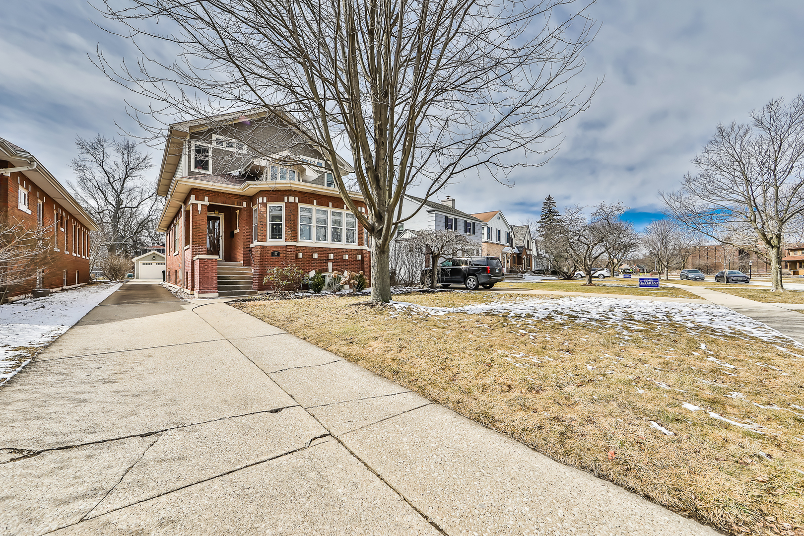 117 Southcote Road Riverside, IL 60546 - Photo 2 of 39 a view of a white house with a snow on the road