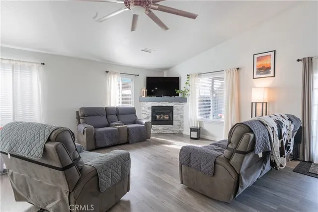 a living room with furniture a flat screen tv and a fireplace