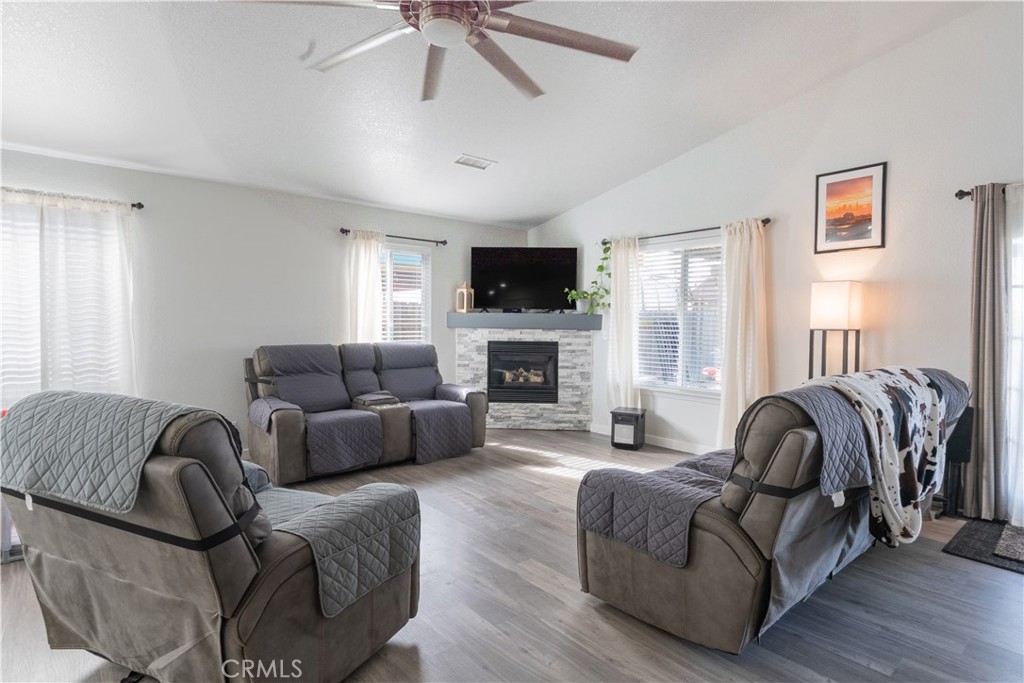 175 South 7th Street Shandon, CA 93461 - Photo 4 of 7 a living room with furniture a flat screen tv and a fireplace