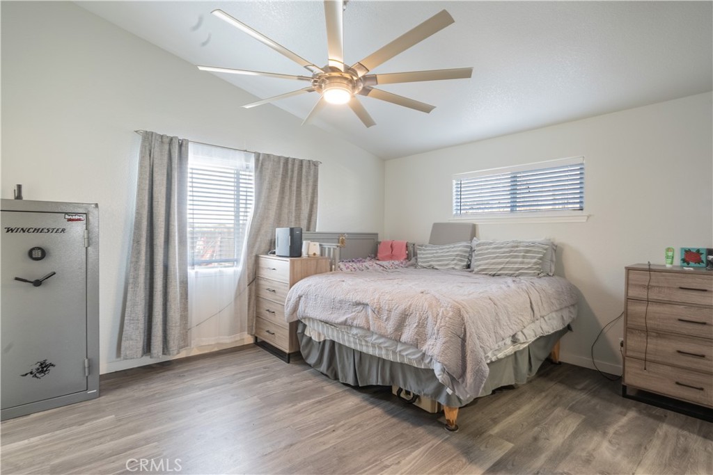 175 South 7th Street Shandon, CA 93461 - Photo 5 of 7 a spacious bedroom with a bed and a ceiling fan