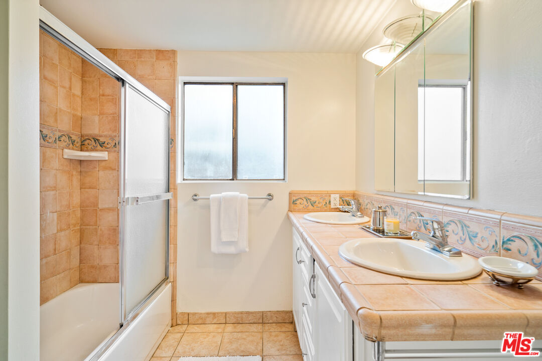 6164 Paseo Cyn Drive Malibu, CA 90265 - Photo 11 of 45 a bathroom with a sink and a mirror