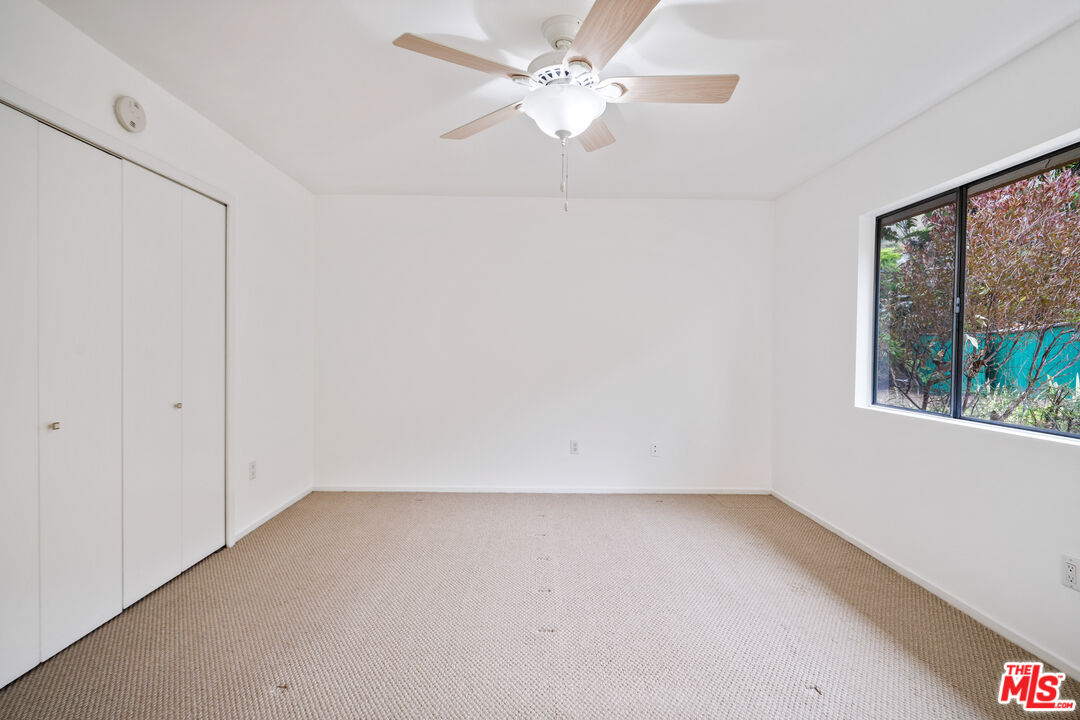 6164 Paseo Cyn Drive Malibu, CA 90265 - Photo 16 of 45 an empty room with a window and a ceiling fan