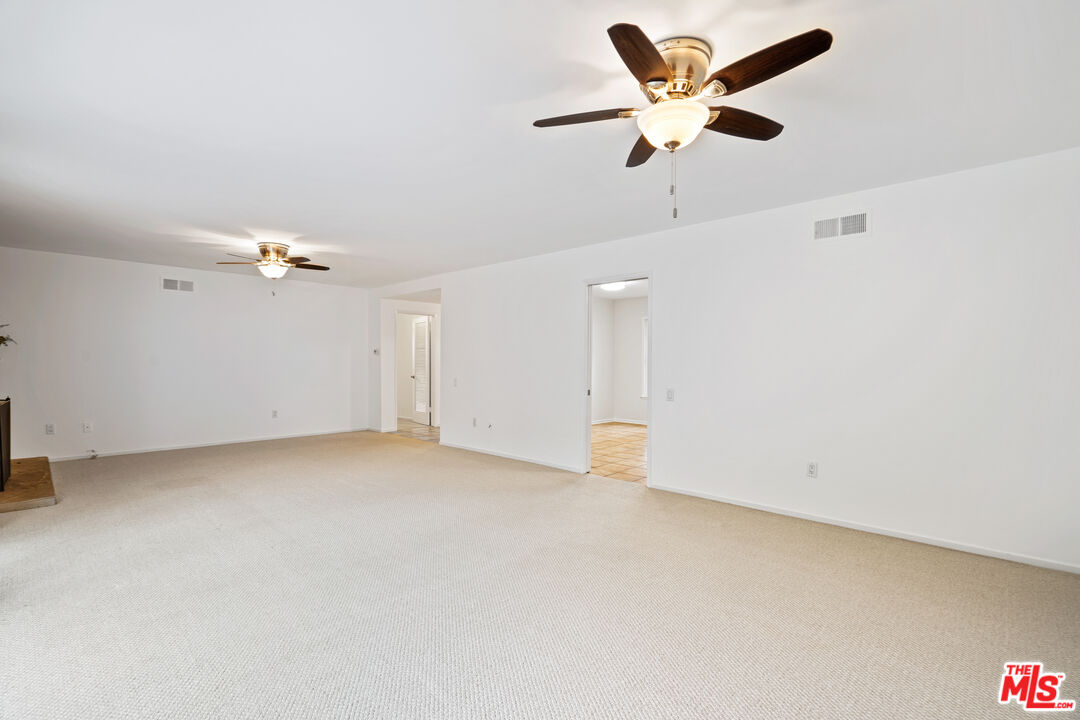 6164 Paseo Cyn Drive Malibu, CA 90265 - Photo 22 of 45 an empty room with ceiling fan and window