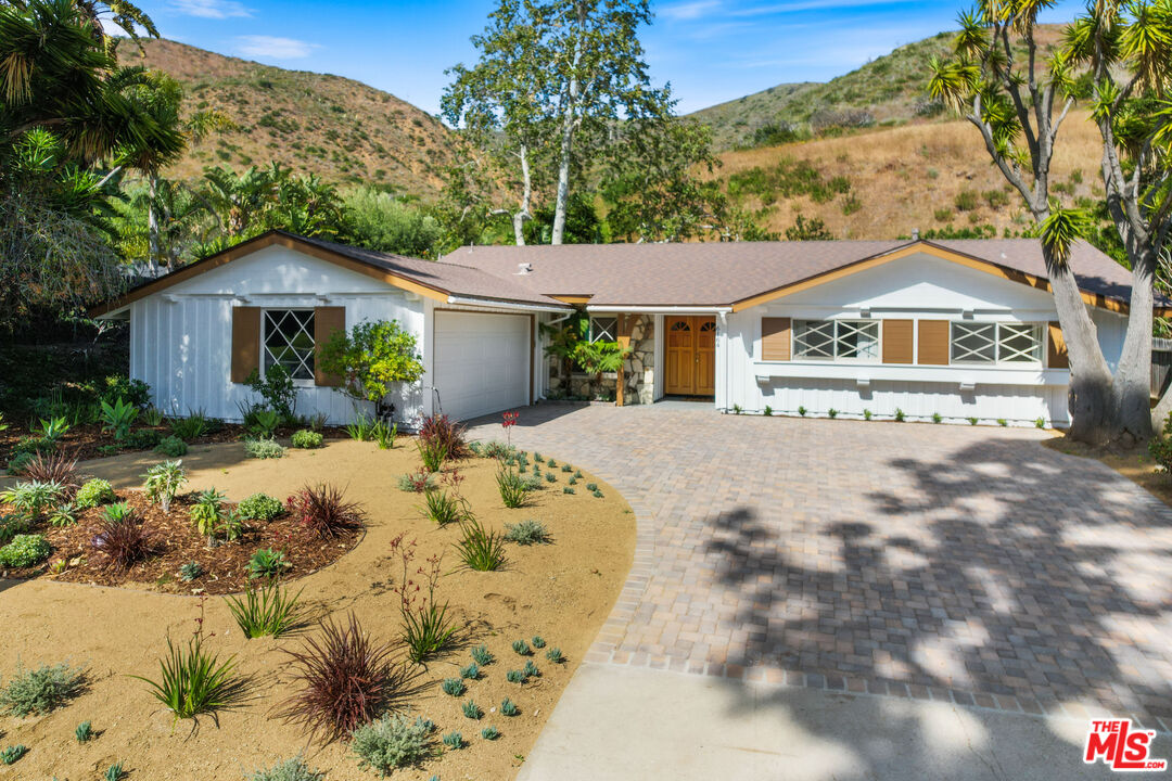 6164 Paseo Cyn Drive Malibu, CA 90265 - Photo 3 of 45 a front view of a house with a yard