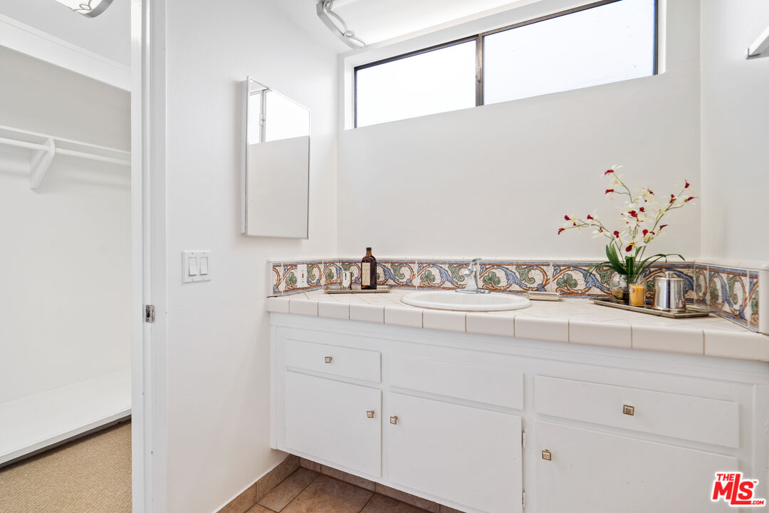 6164 Paseo Cyn Drive Malibu, CA 90265 - Photo 32 of 45 a bathroom with a sink and a mirror