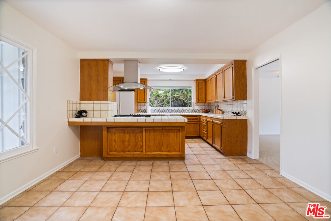 6164 Paseo Cyn Drive Malibu, CA 90265 - Photo 5 of 45 a kitchen with stainless steel appliances a sink window and cabinets