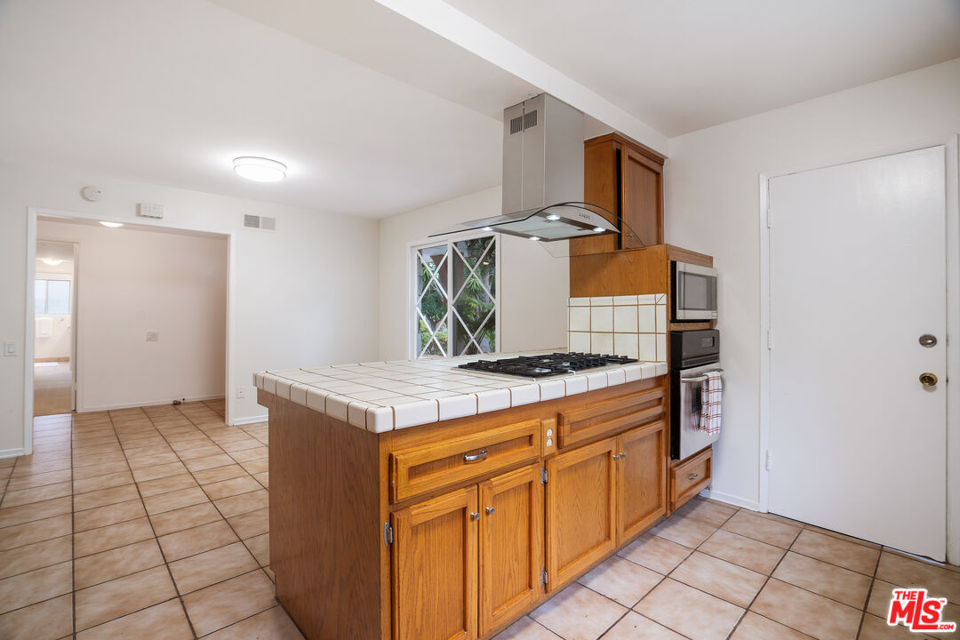 6164 Paseo Cyn Drive Malibu, CA 90265 - Photo 6 of 45 a kitchen with a stove and a sink
