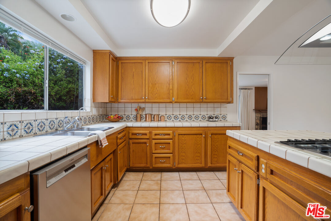 6164 Paseo Cyn Drive Malibu, CA 90265 - Photo 10 of 45 a kitchen with stainless steel appliances granite countertop a sink stove and cabinets