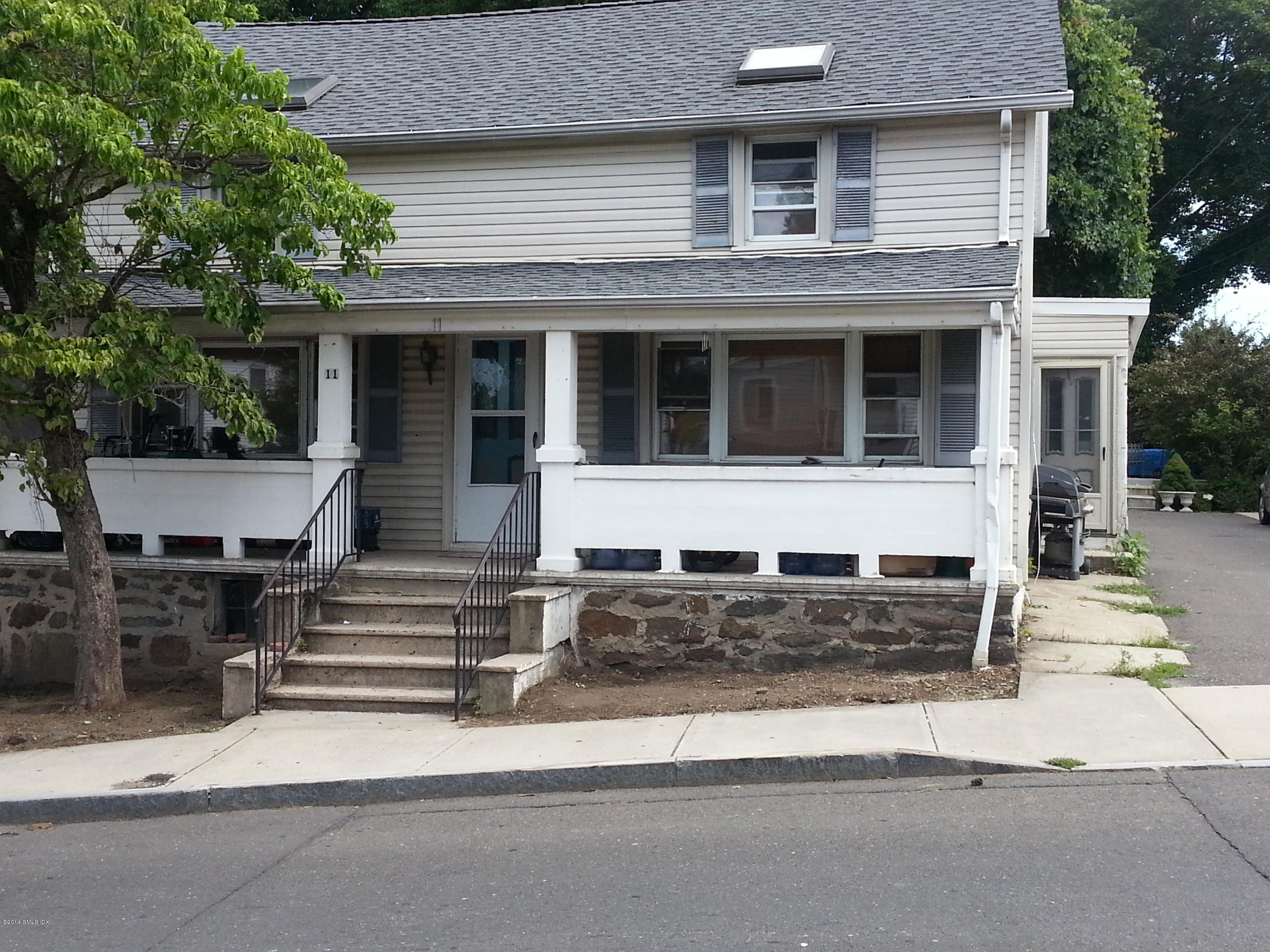 11 St Roch Avenue Greenwich, CT 06830 - Photo 1 of 3 a front view of a house with a yard