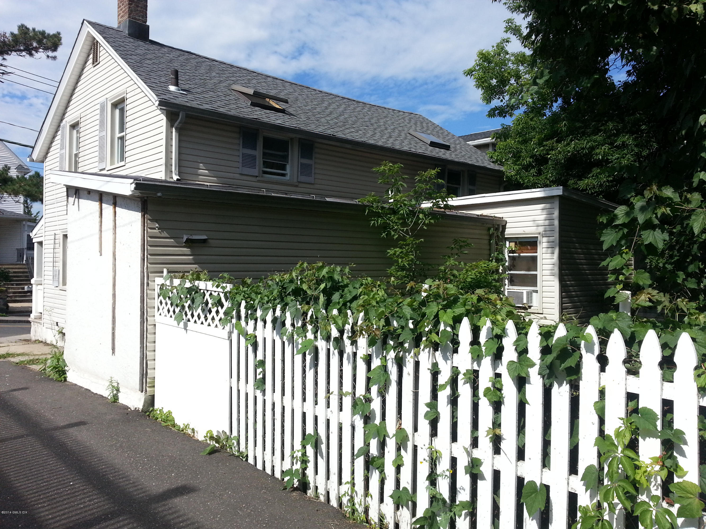 11 St Roch Avenue Greenwich, CT 06830 - Photo 3 of 3 a front view of a house with a yard