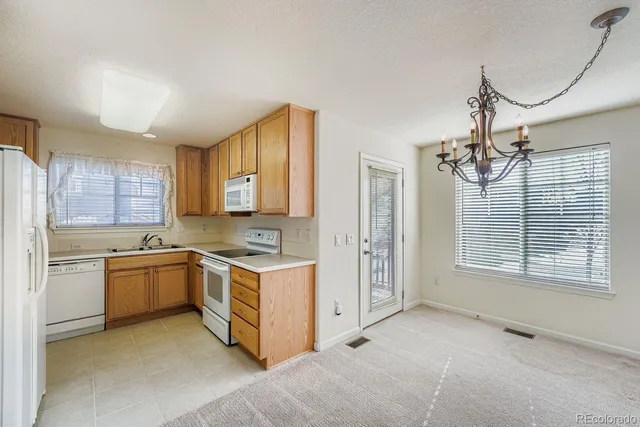 a kitchen with a stove top oven sink and cabinets