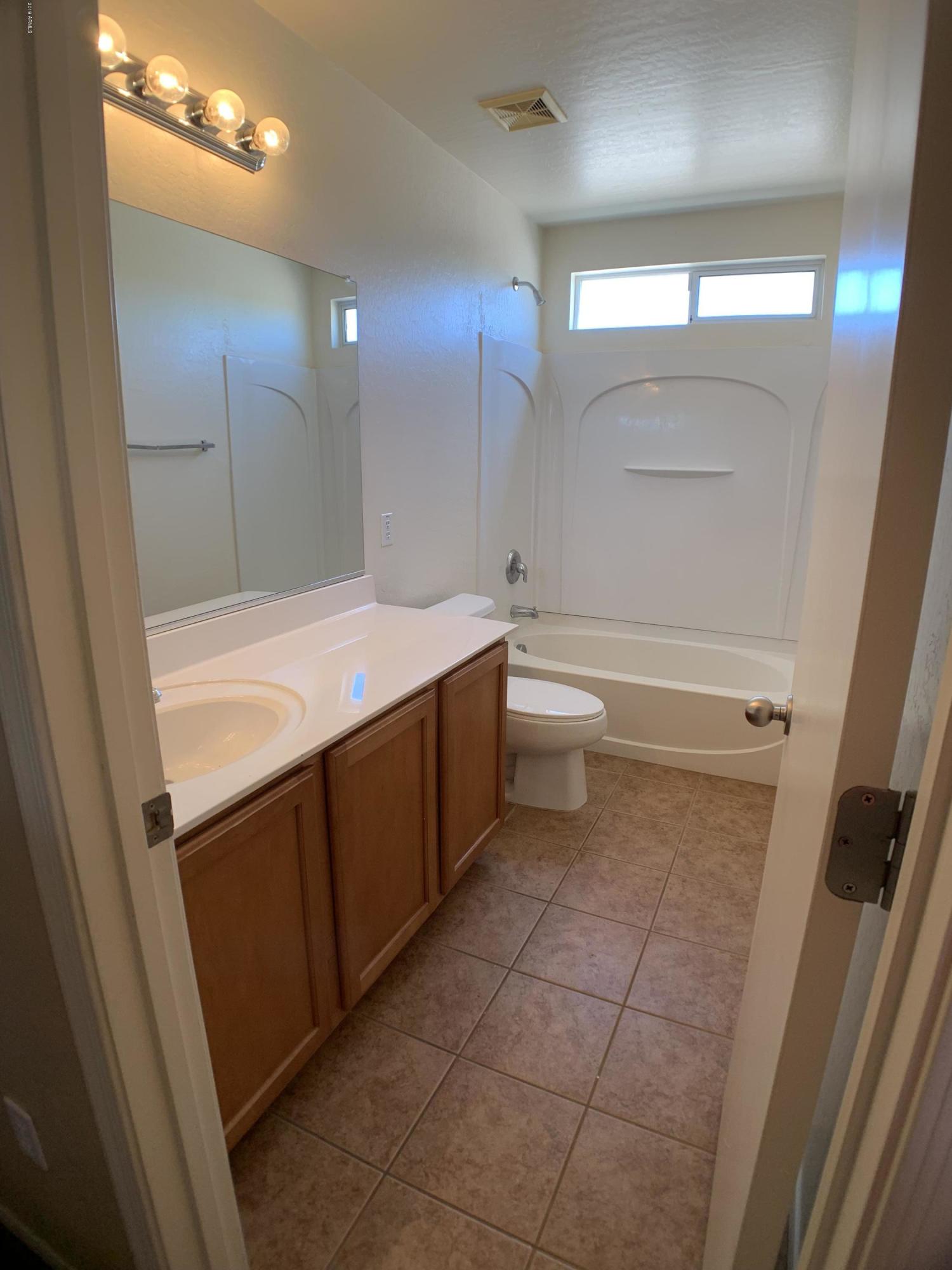 3952 East Morenci Road San Tan Valley, AZ 85143 - Photo 13 of 15 a bathroom with a bathtub sink vanity and a mirror